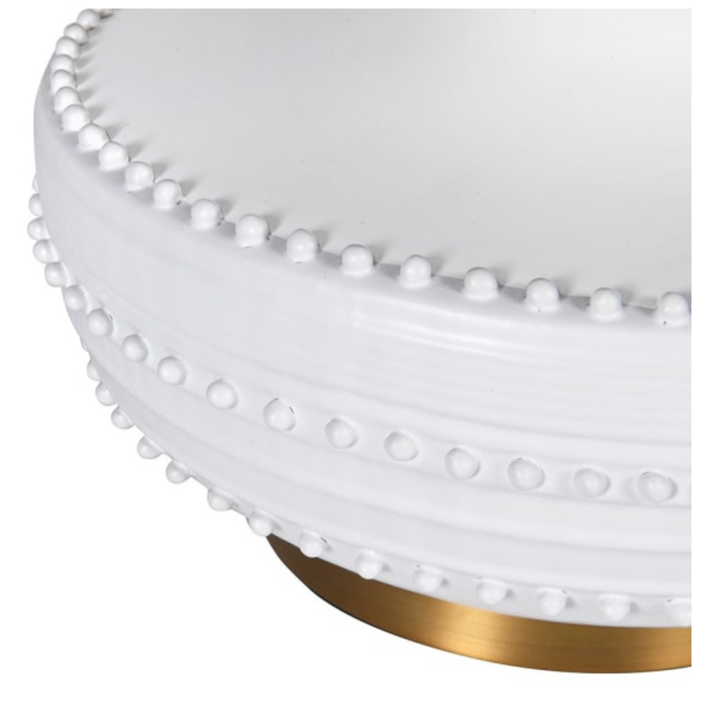 White ottoman with gold base on a white background