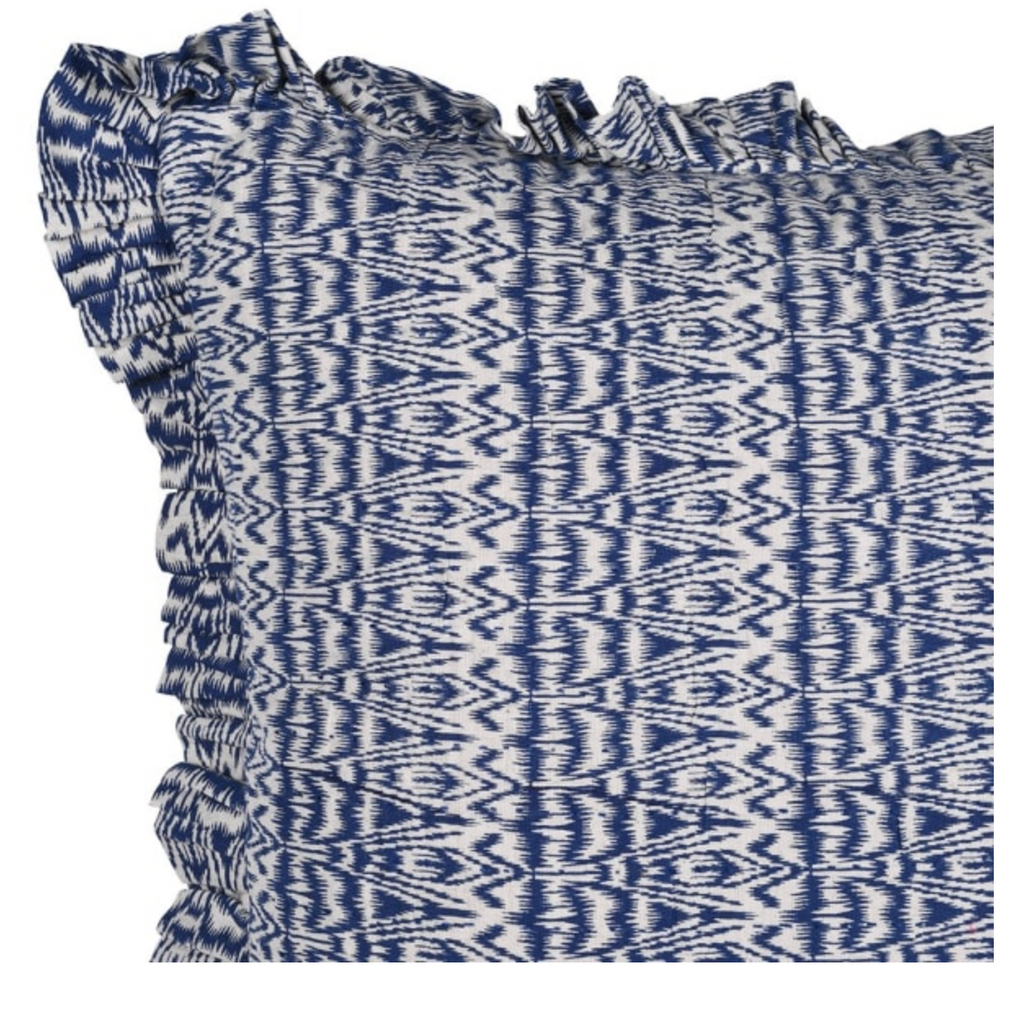 Blue and white patterned fabric with ruffled edges on a white background