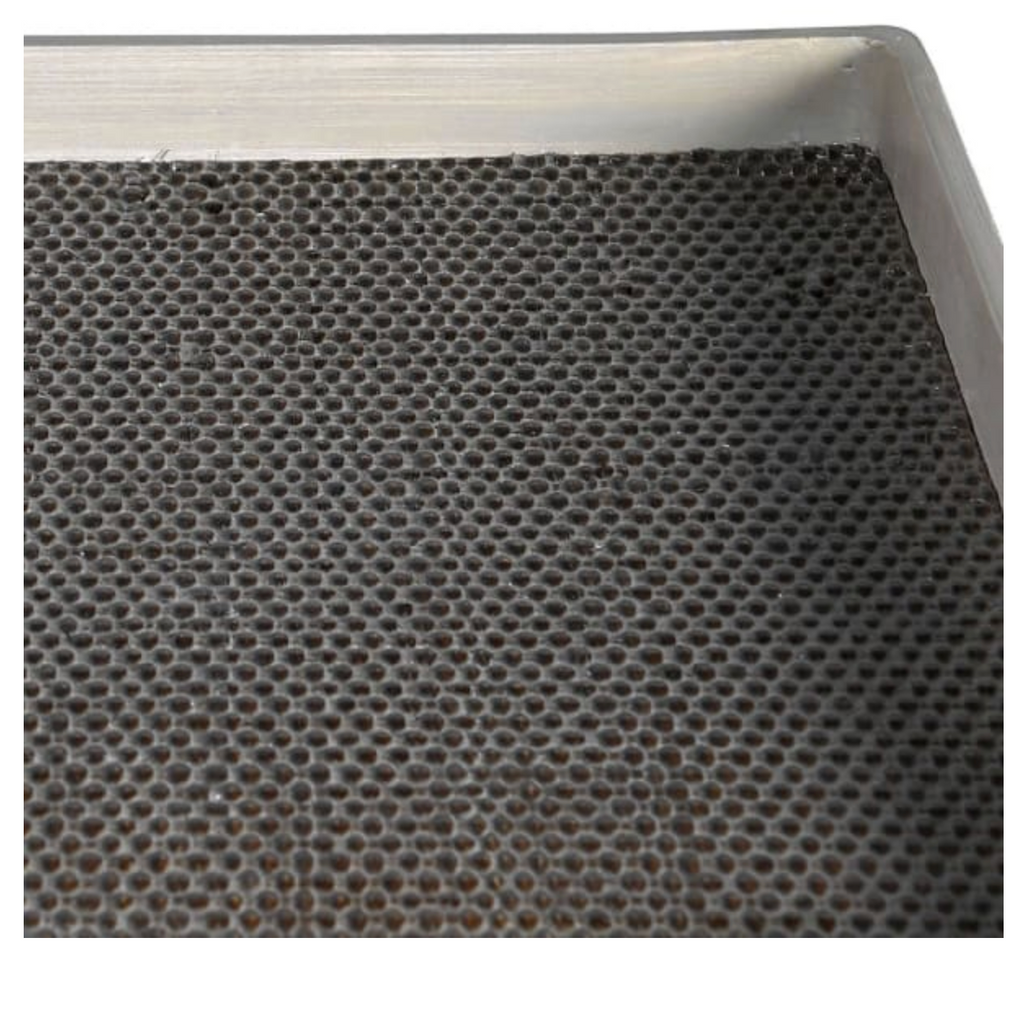 Textured black filter with metallic rim on a white background