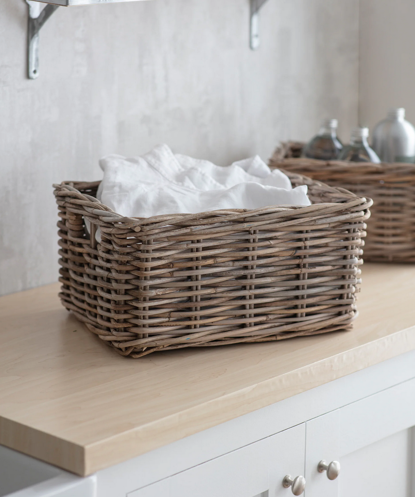 Wicker basket with white fabric on a wooden surface