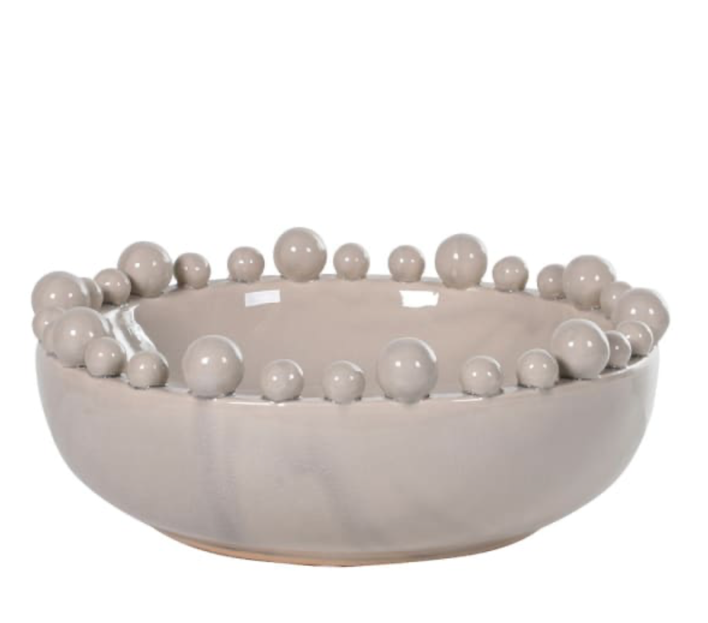 Decorative bowl with spherical embellishments on a white background