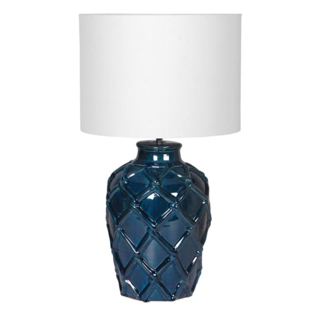 Blue textured table lamp with a white shade on a white background