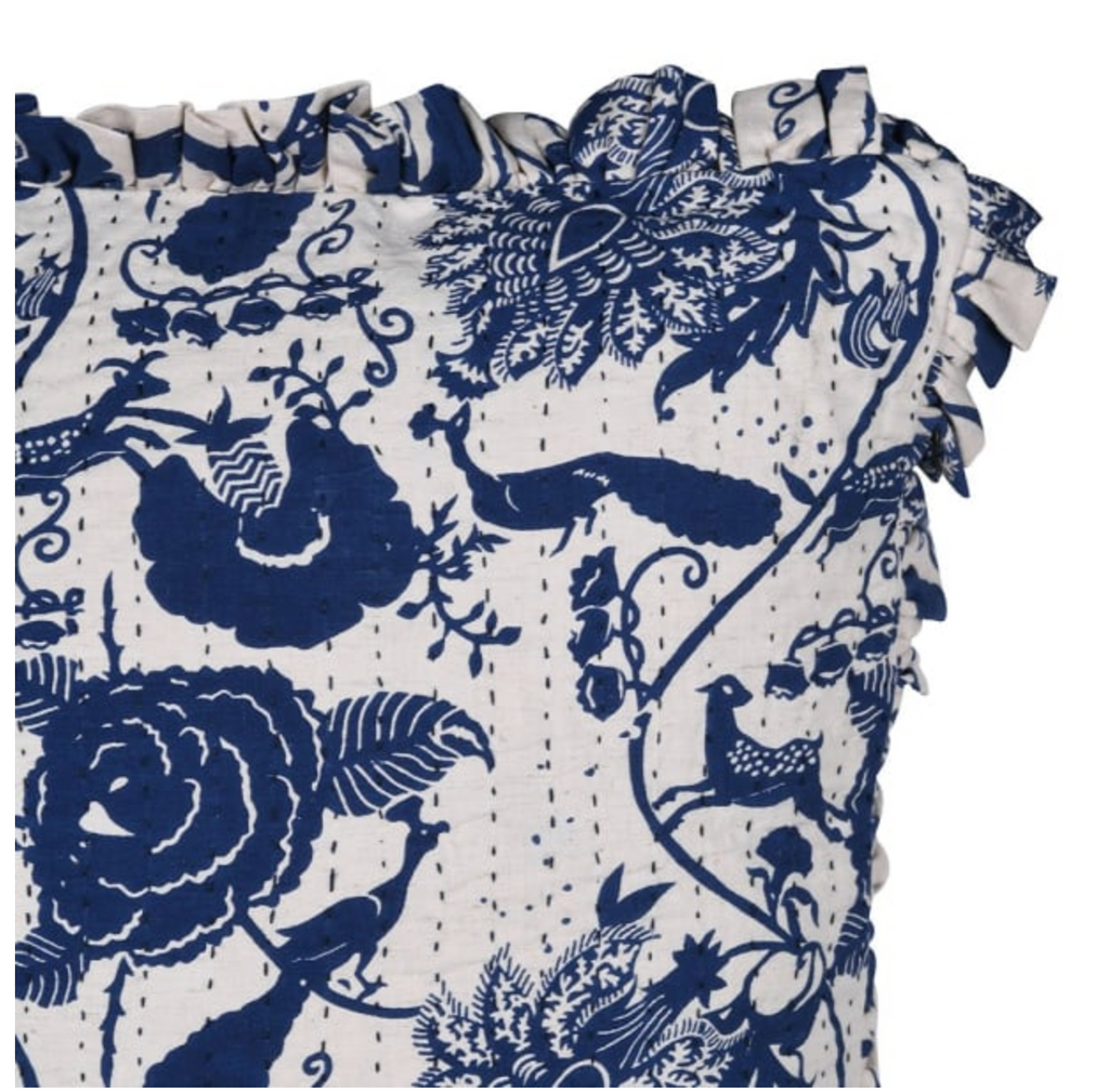 Floral and bird patterned fabric with ruffled edges on a white background