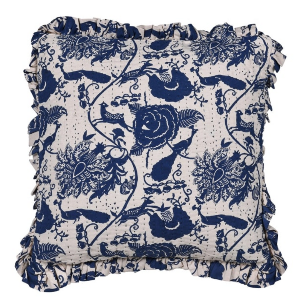 Decorative pillow with blue floral pattern on a white background