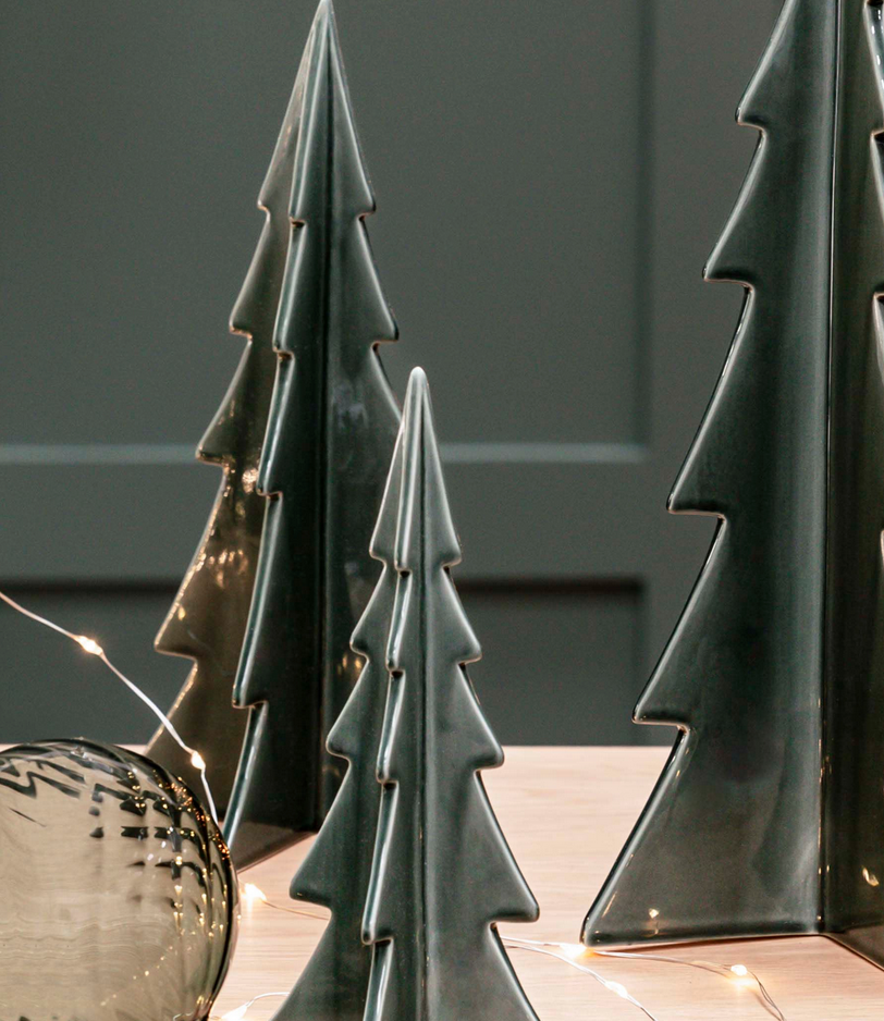 Decorative ceramic trees on a surface with a neutral background