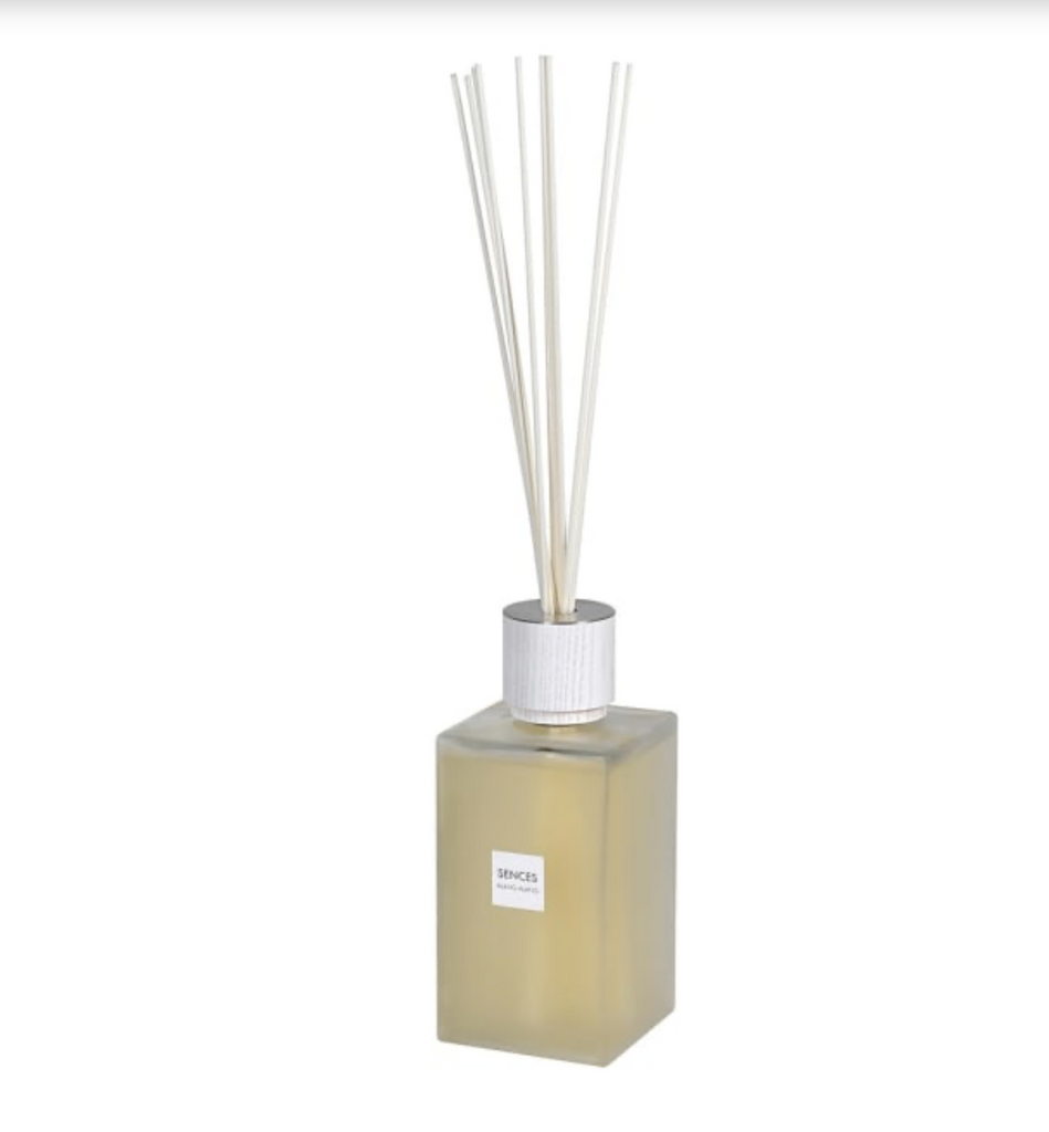 Square diffuser bottle with white sticks on a white background