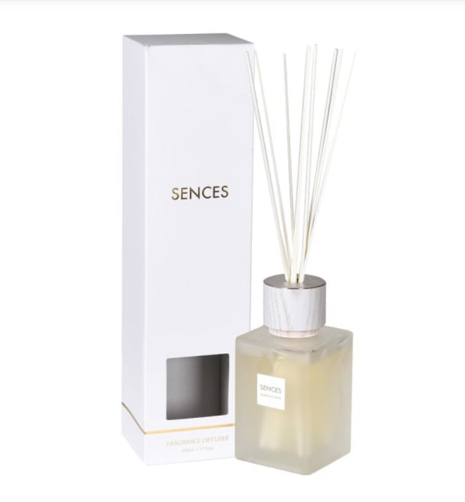 Diffuser bottle with reeds and packaging displaying 'Sences' brand on a white background