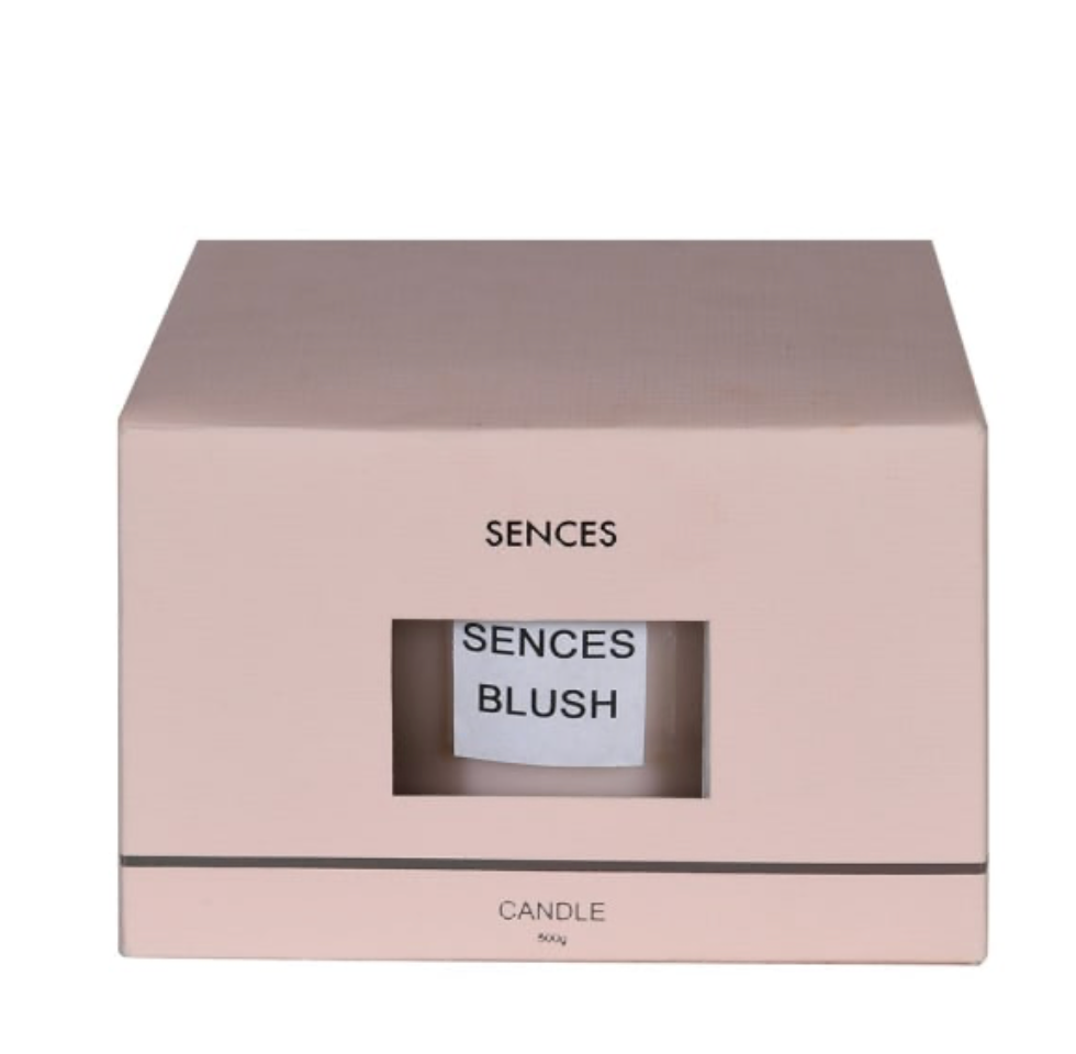 Pink box with 'Sences' branding and a visible candle inside on a white background