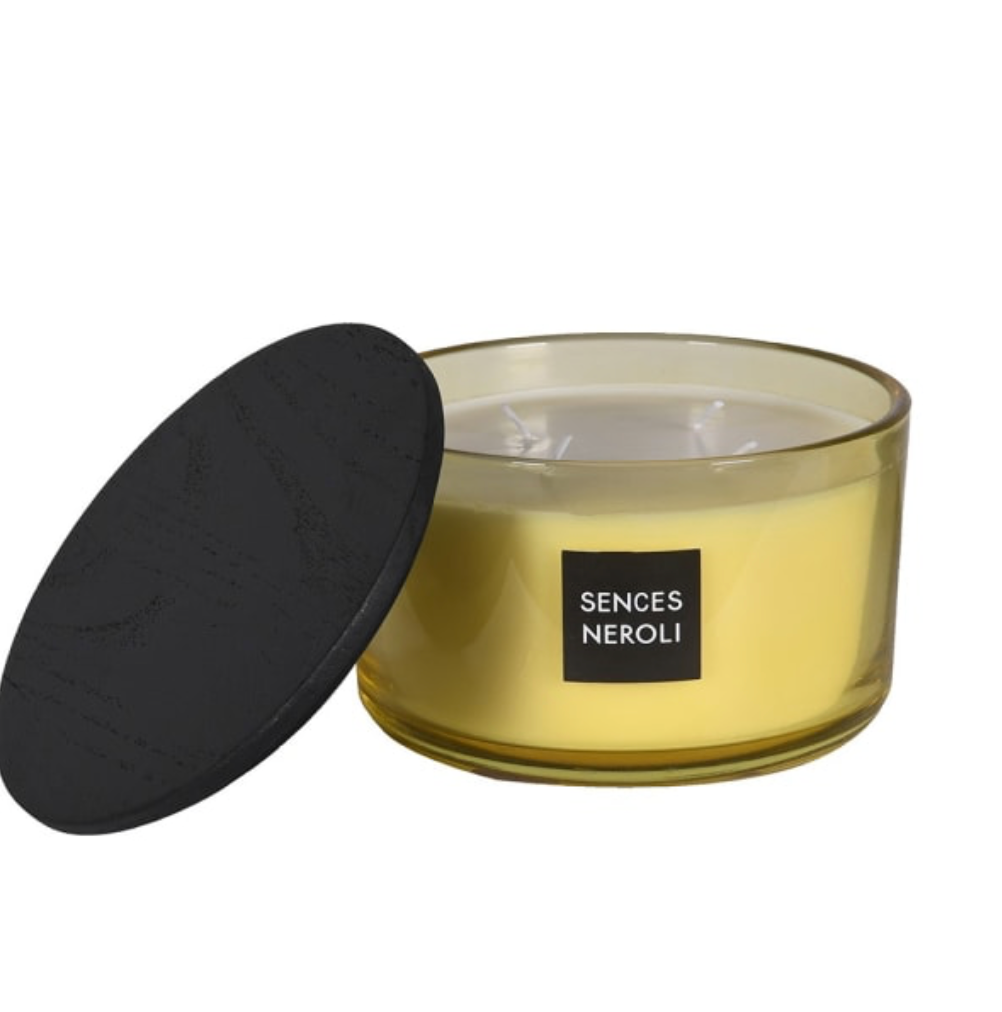Glass candle with black lid and 'Senses Neroli' label on a white background