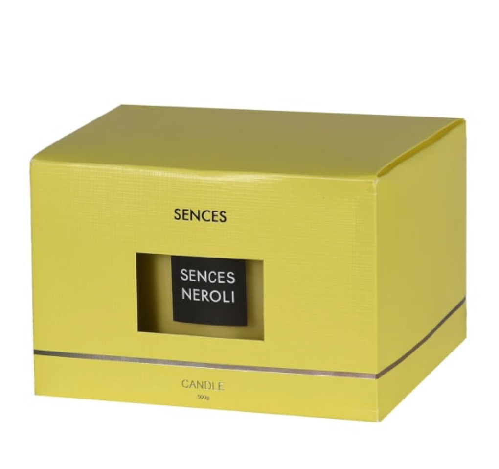 Yellow box with 'Sences' branding and a black label inside on a white background