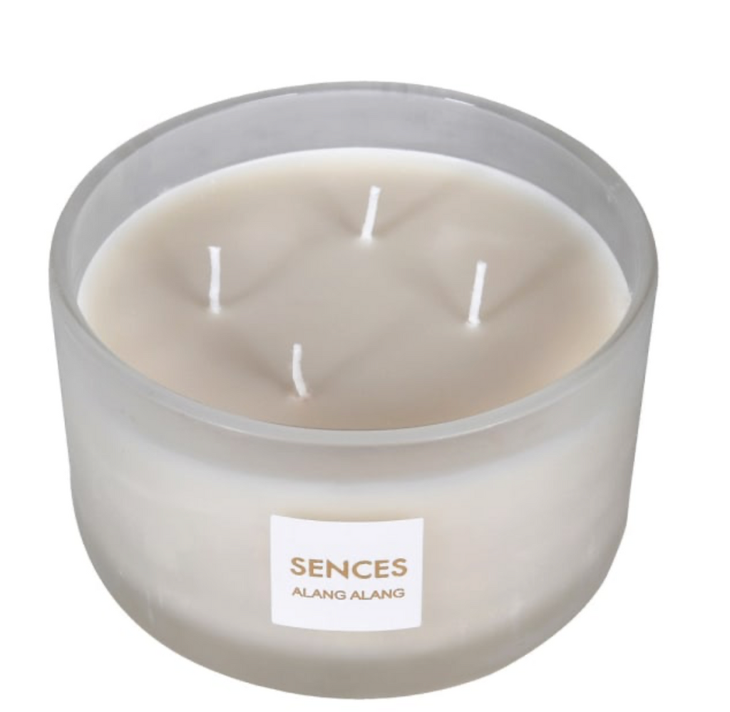 Scented candle in a glass jar with 'Sences' label on a white background